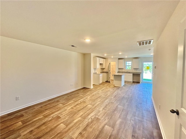 unfurnished living room featuring light hardwood / wood-style floors