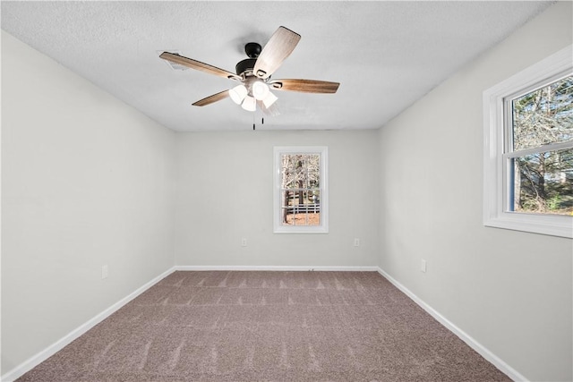 carpeted empty room with a textured ceiling and ceiling fan