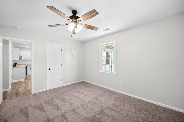 unfurnished bedroom featuring ceiling fan and light colored carpet