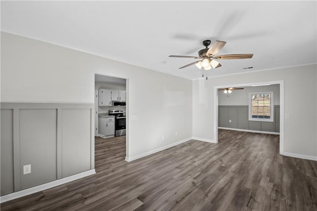 spare room with ceiling fan and dark wood-type flooring