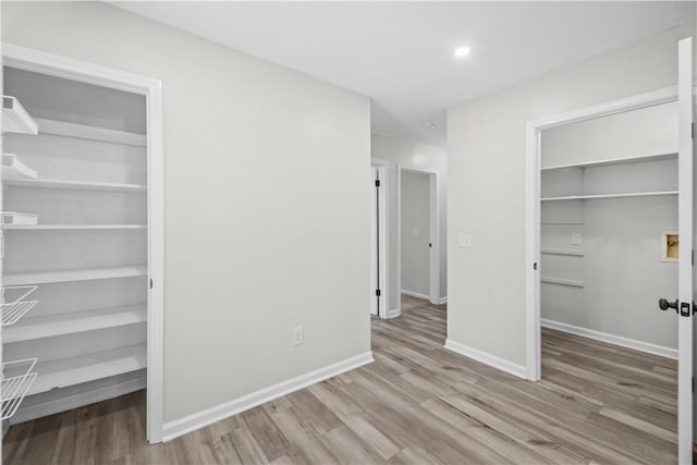 unfurnished bedroom with a closet and light hardwood / wood-style floors