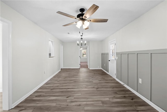 corridor featuring dark hardwood / wood-style floors and a notable chandelier