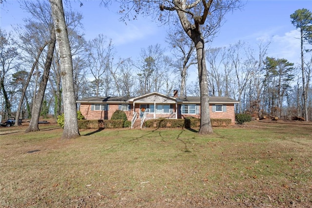 ranch-style house featuring a porch and a front yard