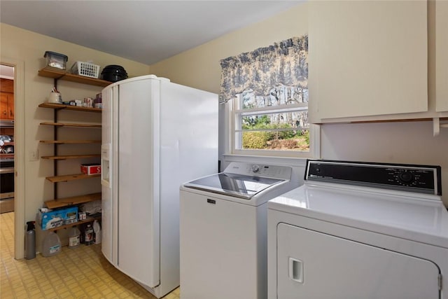 washroom featuring washer and dryer and cabinets