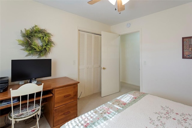 carpeted bedroom with ceiling fan and a closet