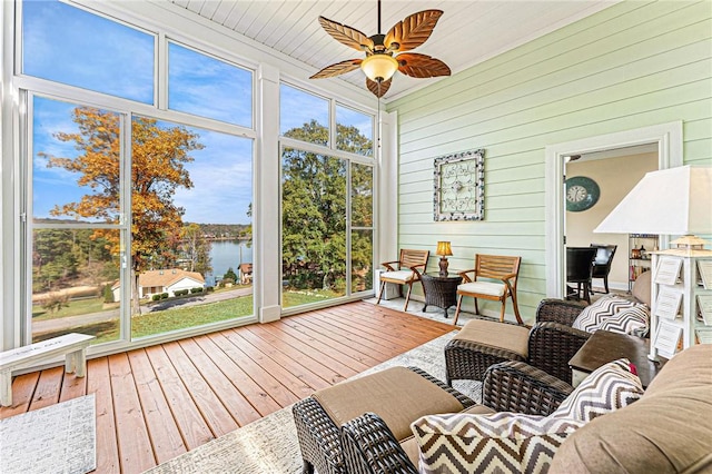 sunroom / solarium with a wealth of natural light, a water view, and ceiling fan