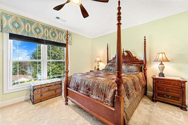 bedroom featuring ceiling fan, crown molding, and light carpet