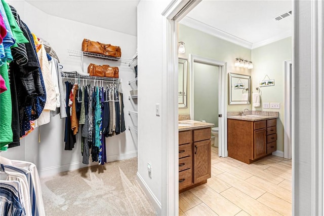 bathroom featuring crown molding, vanity, and toilet