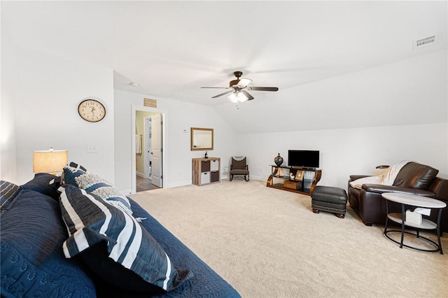 carpeted bedroom with ceiling fan and vaulted ceiling