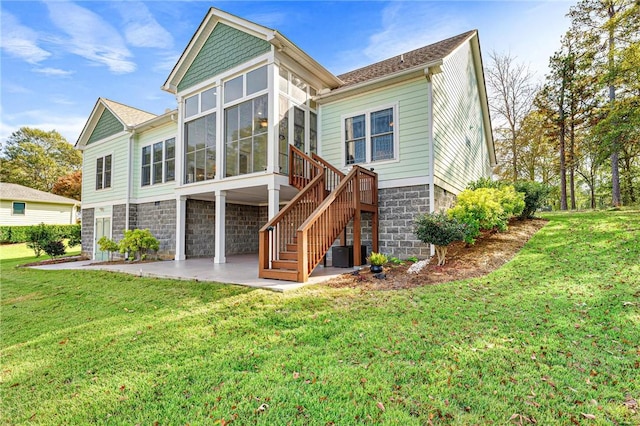 rear view of house featuring a sunroom, a yard, a patio, and central AC