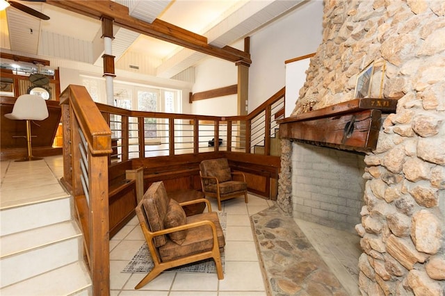 interior space with ceiling fan, beamed ceiling, and light tile patterned floors