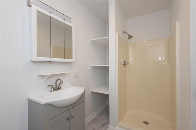 bathroom featuring a shower and vanity