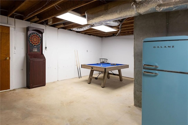 basement featuring white refrigerator and billiards