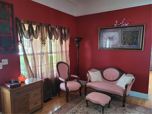 living area featuring baseboards and wood finished floors