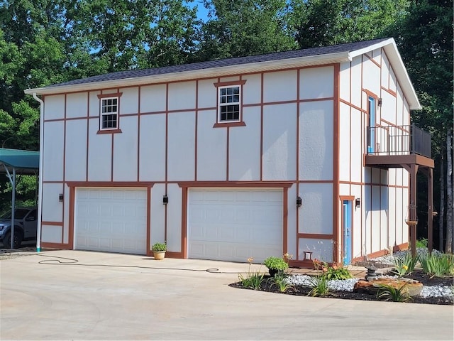 exterior space featuring concrete driveway and an attached garage