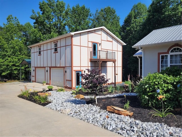 view of outbuilding with driveway and an attached garage