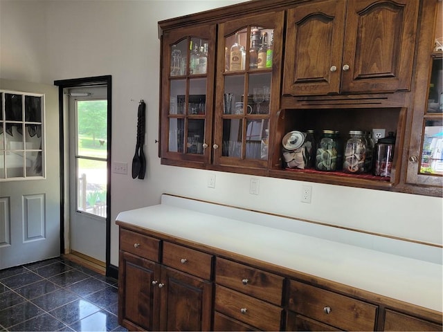 bar with granite finish floor and baseboards