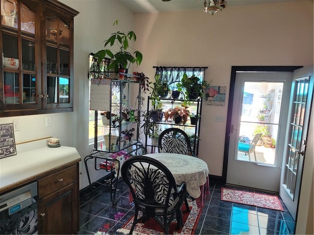 dining area featuring dark tile patterned floors