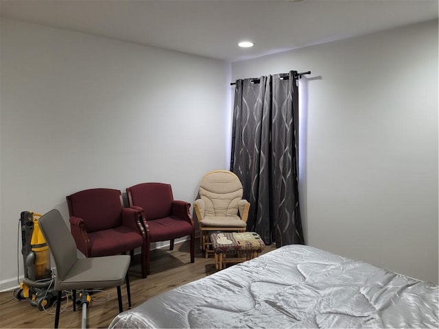 bedroom featuring baseboards, wood finished floors, and recessed lighting