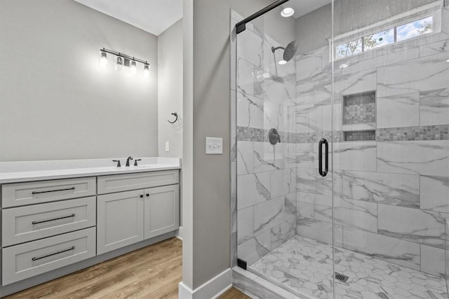 bathroom featuring hardwood / wood-style flooring, sink, and walk in shower