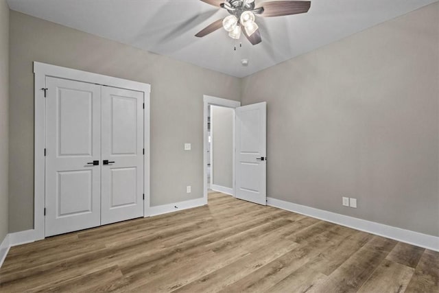 unfurnished bedroom featuring ceiling fan, a closet, and light hardwood / wood-style floors