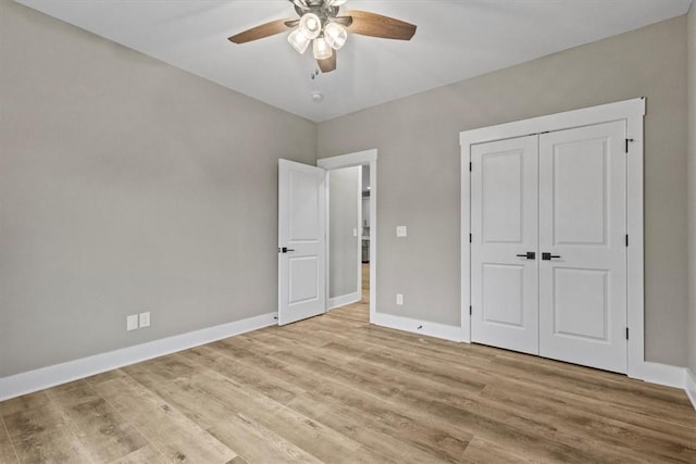 unfurnished bedroom featuring ceiling fan, a closet, and light hardwood / wood-style flooring