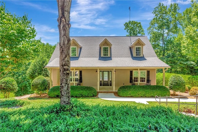 new england style home with covered porch