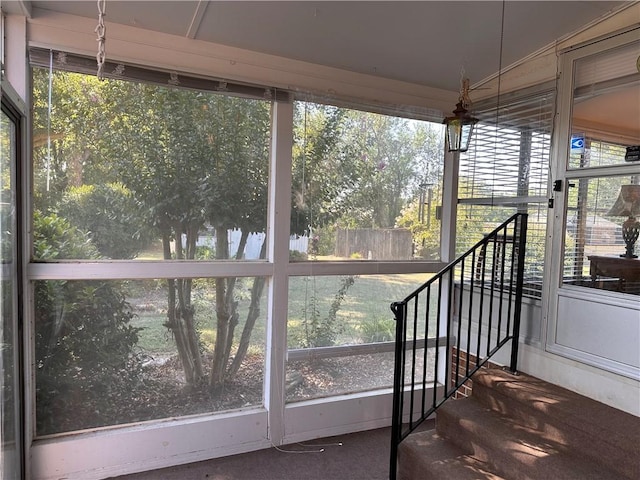 unfurnished sunroom with lofted ceiling