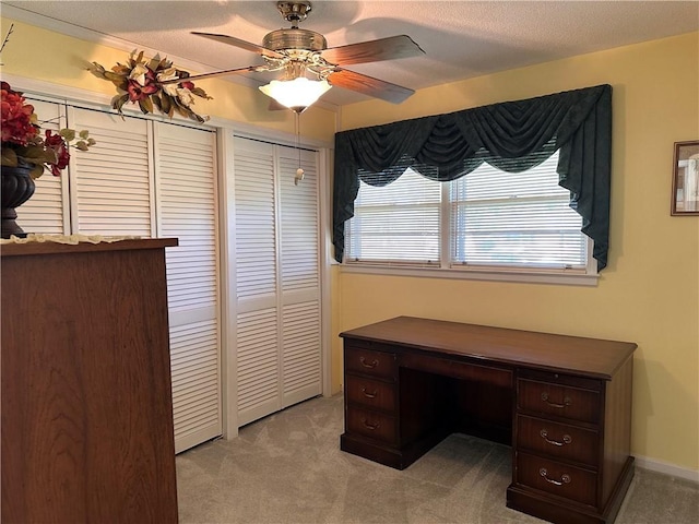 office with ceiling fan, light colored carpet, and a textured ceiling