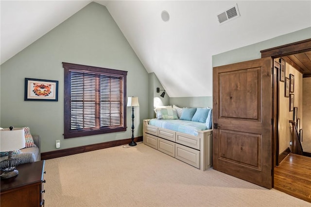 carpeted bedroom featuring vaulted ceiling