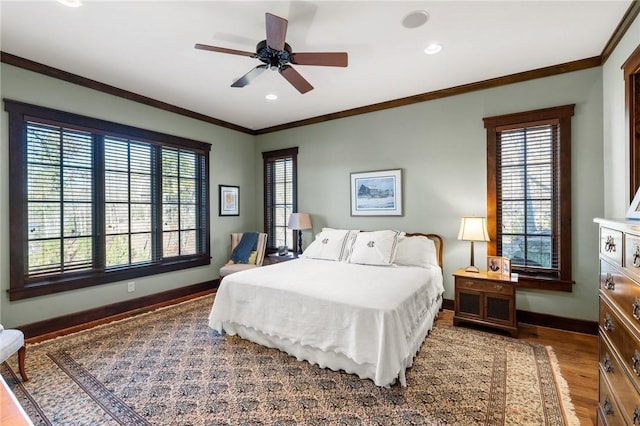 bedroom featuring ceiling fan, hardwood / wood-style flooring, and ornamental molding