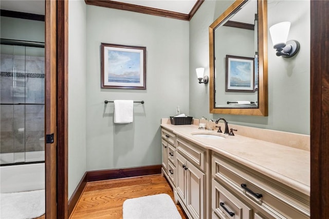 bathroom with vanity, wood-type flooring, and ornamental molding