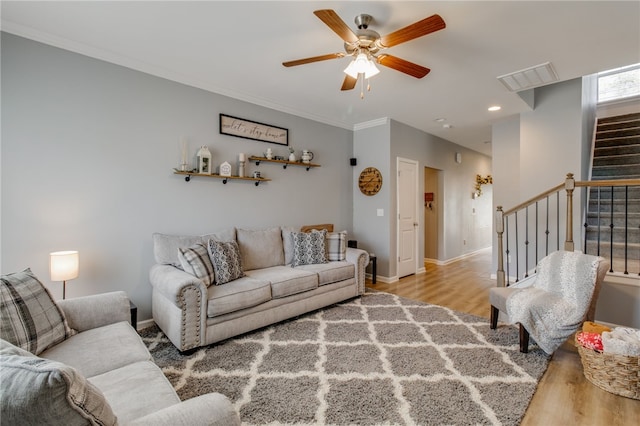 living room featuring ceiling fan and light hardwood / wood-style floors