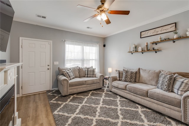 living room featuring ceiling fan, ornamental molding, and hardwood / wood-style flooring