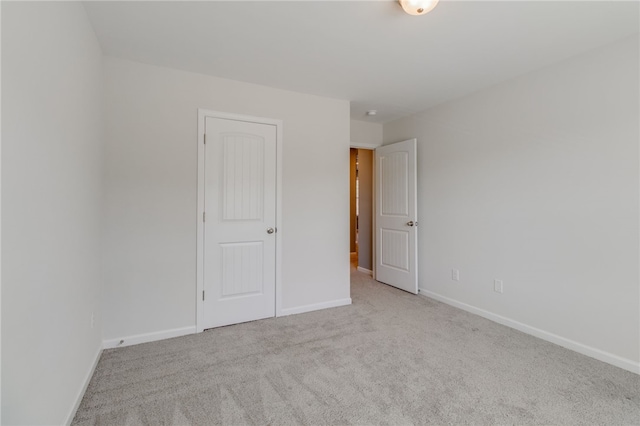 empty room featuring light colored carpet