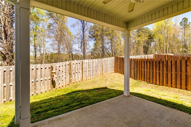 view of yard with ceiling fan and a patio