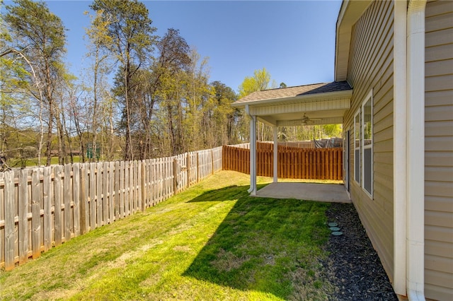 view of yard featuring ceiling fan and a patio area