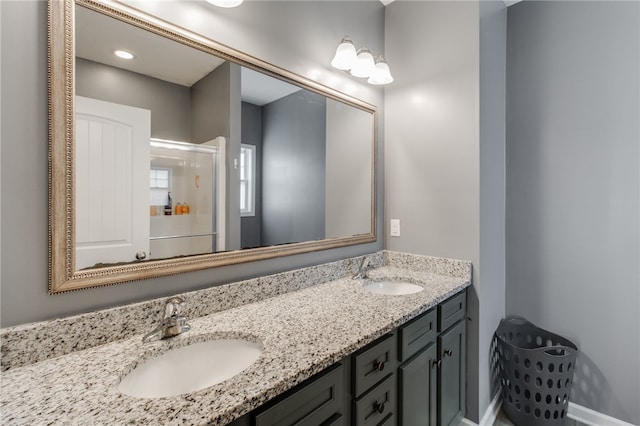 bathroom featuring vanity and an enclosed shower