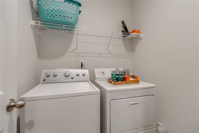 clothes washing area featuring independent washer and dryer