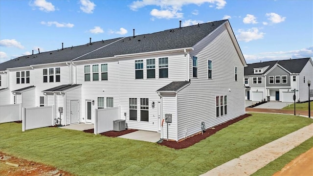 back of property with a yard and central AC unit