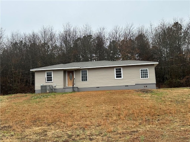 view of front of property with a front yard and central air condition unit