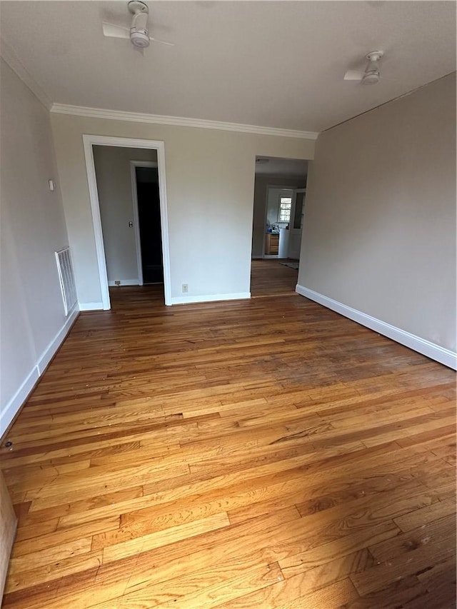 spare room featuring ceiling fan, light hardwood / wood-style floors, and ornamental molding