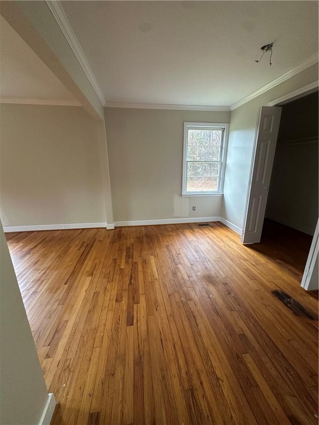 unfurnished bedroom with light hardwood / wood-style floors and crown molding