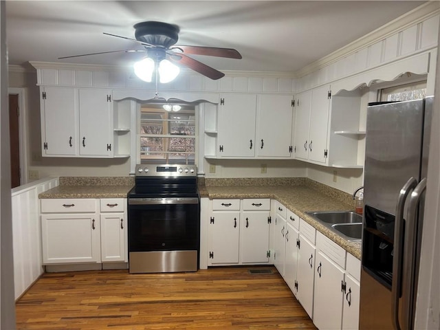 kitchen featuring dark hardwood / wood-style flooring, sink, stainless steel appliances, and white cabinetry