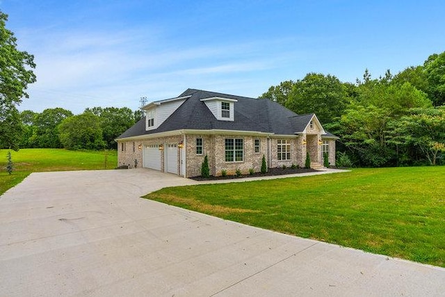 view of front of house with a garage and a front lawn