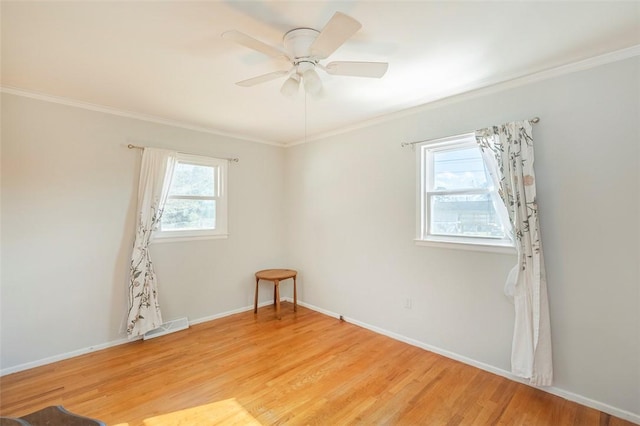 empty room with light hardwood / wood-style floors, ceiling fan, and crown molding