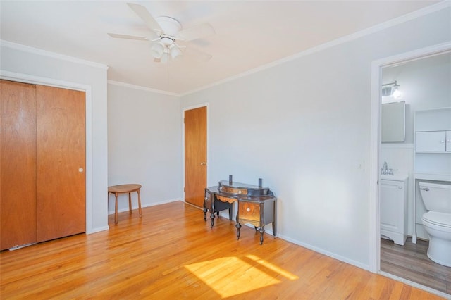 bedroom featuring ensuite bath, ceiling fan, a closet, and light hardwood / wood-style flooring