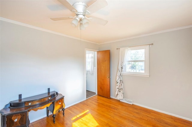 interior space with ceiling fan, light hardwood / wood-style floors, and ornamental molding