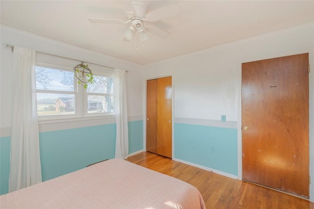 bedroom with wood-type flooring and ceiling fan