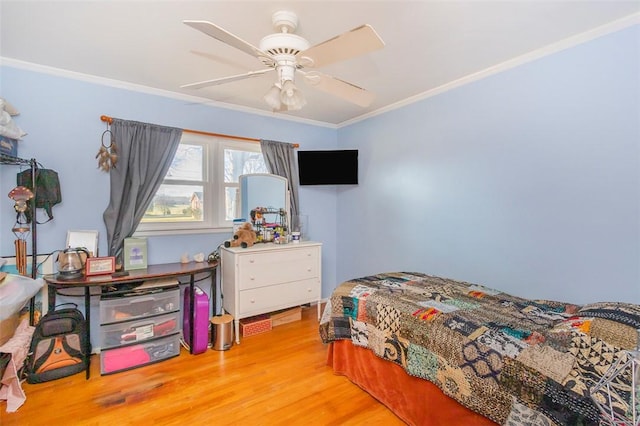 bedroom with ceiling fan, crown molding, and light wood-type flooring